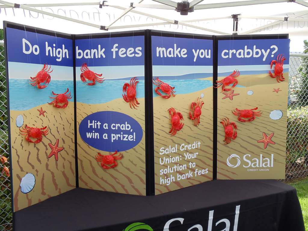 Tabletop sign with an interactive game promoting Salal Credit Union at the South Lake Union block party
